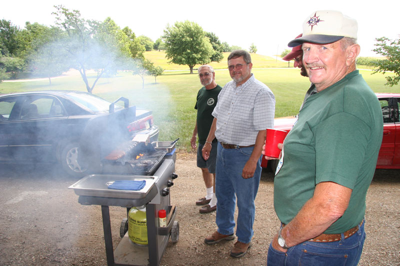 The cook and quality control agents watching the grill