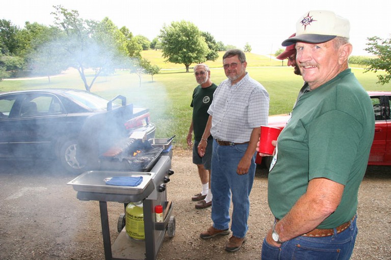 The cook and quality control agents watching the grill